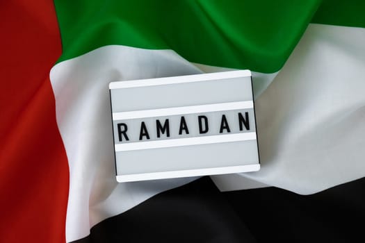 Congratulations Lightbox with text RAMADAN waving UAE flag on background concept. Greeting card advertisement. Commemoration Day Muslim Blessed holy month public holiday