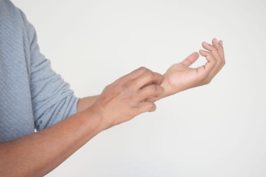 man suffering from itching skin, close up