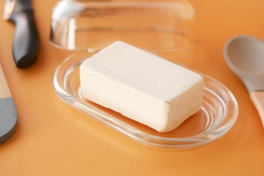 fresh butter in a glass jar on table .