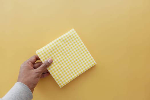 hand pull out a piece of yellow color tissue ,