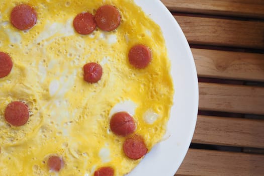 Egg Omelette with sausage on table .