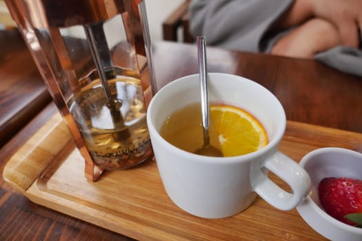 a cup of lemon tea on a table .