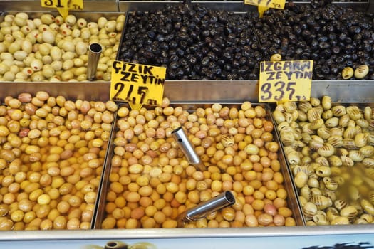 Buckets of olives for sale street food market.