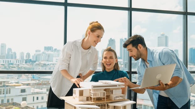 Smart architect team discussion about house design while handsome male worker present idea by using laptop. Group of professional engineer sharing, brainstorming design. Business design. Tracery