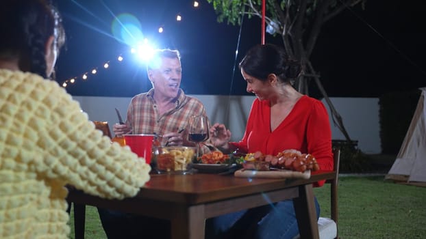 Family gather celebrate holiday. Parents, grandparents and girl together to talk and have dinner party food. Outdoor activity for spending time with multigeneration cross generation gap. Divergence.