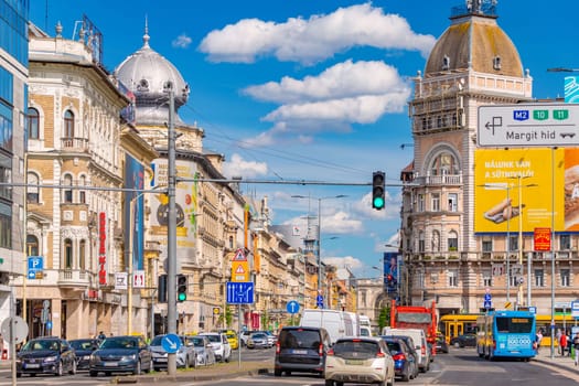 Budapest, Hungary - 3 April 2024: View of Rakoczi Avenue with car traffic and historical buildings.