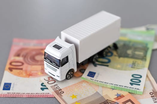 white toy truck on euro banknotes. concept for logistics, transportation and and finance. High quality photo