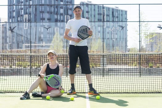Ukraine Kyiv, April 02 2024. Padel training coach in a session, mentoring a female student, fostering skill development and a positive learning environment. High quality photo