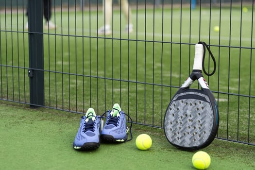 paddle tennis racket and balls on court . High quality photo