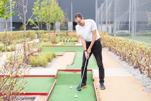 Minigolf player detail on green grass. High quality photo