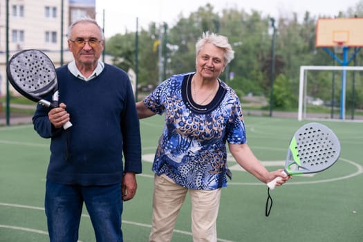 senior man playing paddle tennis . High quality photo