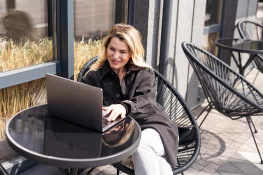 Young woman with laptop outside. High quality photo