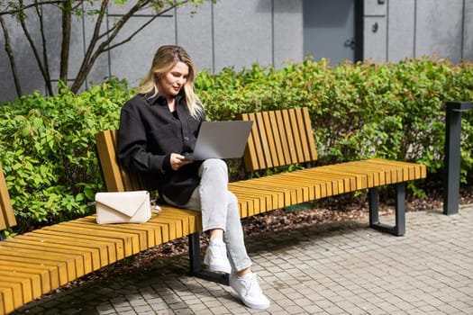 Young woman working at a remote job in a cafe. High quality photo