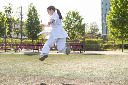 young girl in a white kimono, karate. High quality photo