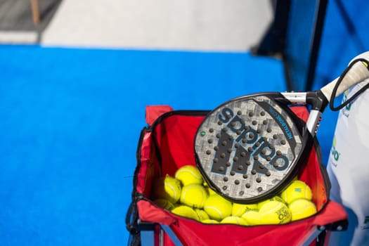 Ukraine Kyiv, April 02 2024. paddle tennis racket and balls on the blue paddle court. High quality photo