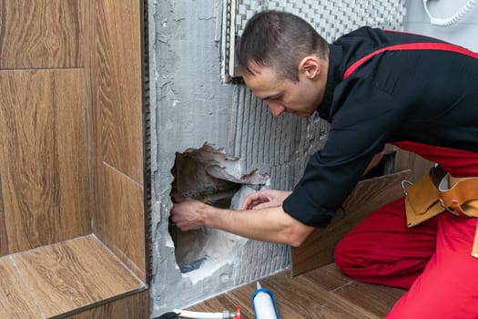 Construction worker with spirit level working on home renovations. High quality photo