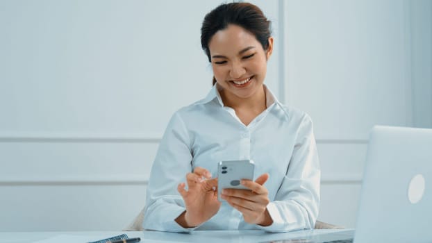 Young woman using smartphone browsing for online shopping E commerce by online payment gateway at vivancy home. Modern and convenience online purchasing make secure and convenient purchases.