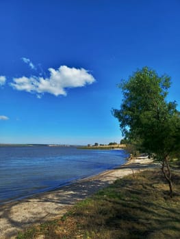 Clouds float over the Dniester estuary. Sunny weather and light breeze.