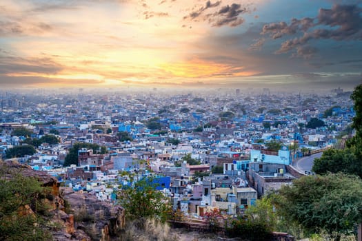 aerial drone shot showing jodhpur blue city cityscape showing traditional houses in middle of aravalli with colorful densely packed houses India