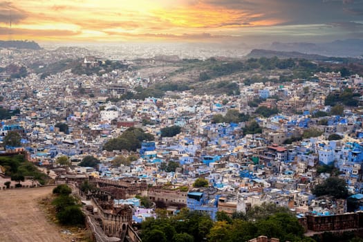 aerial drone shot showing jodhpur blue city cityscape showing traditional houses in middle of aravalli with colorful densely packed houses India