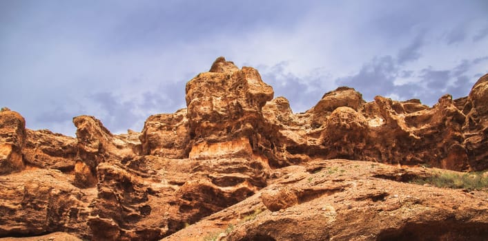 Red rock wall of the Charyn canyon in the national park of the Almaty region. Picturesque nature of middle asia.