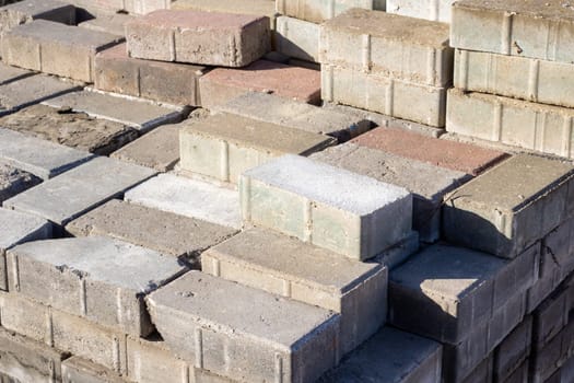 A stack of bricks placed one on top of the other, used in construction. The bricks form a sturdy, durable structure, often creating a pattern in the landscape