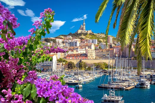 City of Marseille harbor and Notre Dame de la Garde church on the hill flower and palm view, southern France