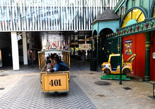 A childrens train ride rides through the Tivoli amusement park in Copenhagen. High quality photo