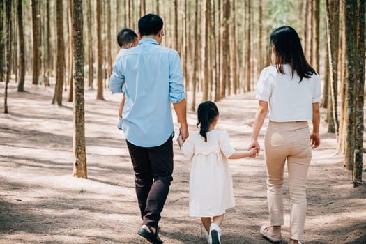 A mother and her daughter holding hands, walking through the countryside on a sunny summer morning, Happy family day