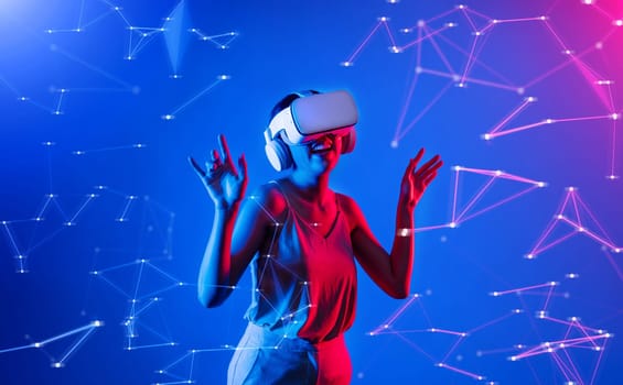 Female standing wearing white VR headset and tank top connecting metaverse, future cyberspace community technology, enjoy dancing in cyberpunk neon light gesticulate hand and body. Hallucination.