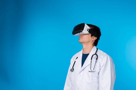 Smart doctor looking through VR headset connecting metaverse analytical medicine research isolated blue background futuristic technology hologram virtual reality intelligent meta world. Contrivance.