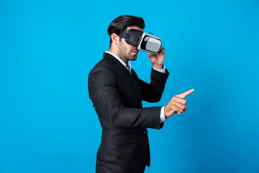 Project manager with virtual reality glasses looking at data analysis while analyzing and pointing data. Skilled business man using VR goggle and digital innovation while enter metaverse. Deviation.