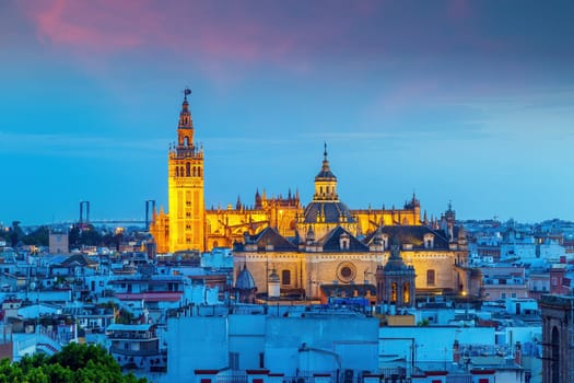 Giralda tower and Seville Cathedral in downtown Spain at sunset from top view