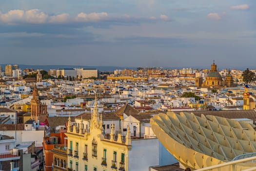 Metropol Parasol wooden structure with Seville city skyline in the old quarter of Seville in Spain at sunset