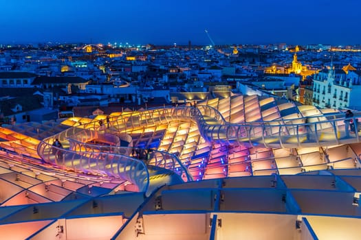 Metropol Parasol wooden structure with Seville city skyline in the old quarter of Seville in Spain at sunset