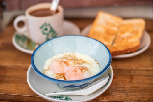 Traditional oriental Chinese kopitiam style in Melaca Malysia eggs bread and coffee 