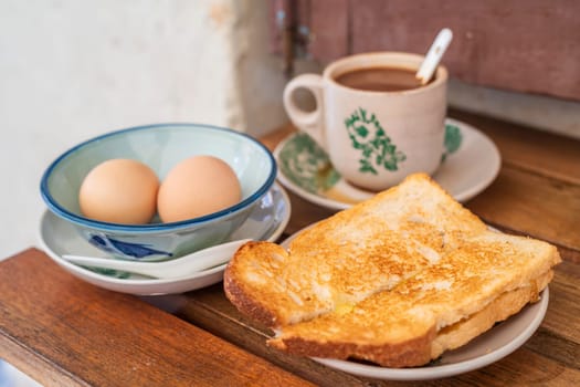 Traditional oriental Chinese kopitiam style in Melaca Malysia eggs bread and coffee 