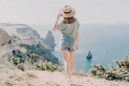 Woman travel sea. Happy carefree sensual woman with long hair in black swimwear posing at sunset beach. Silhouette of young beautiful playful positive woman outdoor. Summer vacation and trip concept