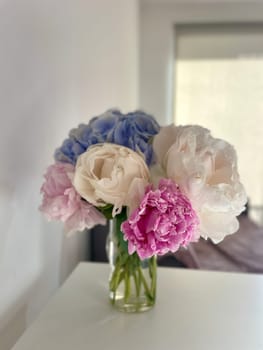 A bouquet of blooming white and pink peonies of delicate color. High quality photo