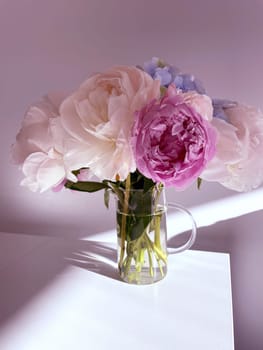 A bouquet of blooming white and pink peonies of delicate color. High quality photo