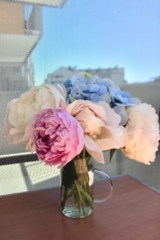 A bouquet of blooming white and pink peonies of delicate color. High quality photo