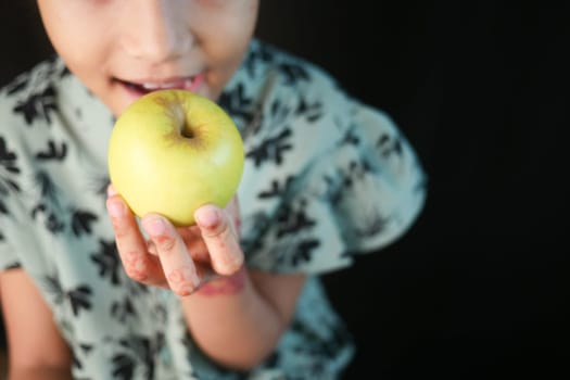 little girl eating apple close up .