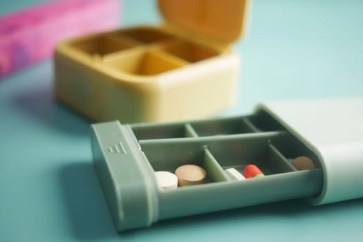 close up of medical pills in a pill box on table .