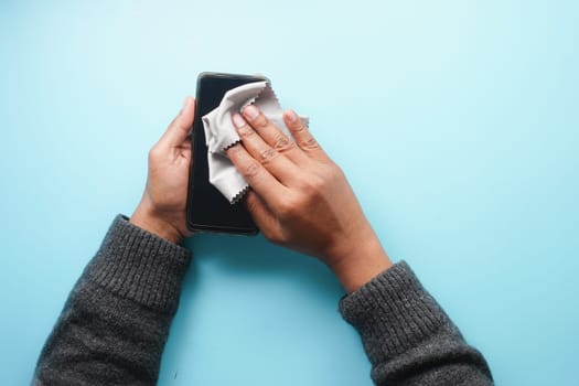 man hand cleaning mobile phone display