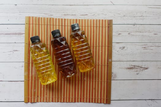 Several bottles of oil arranged on a table for food storage.