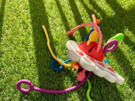 A bright children's toy lies on artificial grass. High quality photo