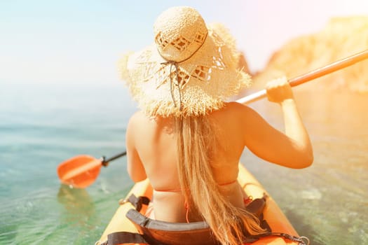 woman straw hat paddling a kayak on a lake. The sun is shining brightly, creating a warm and inviting atmosphere