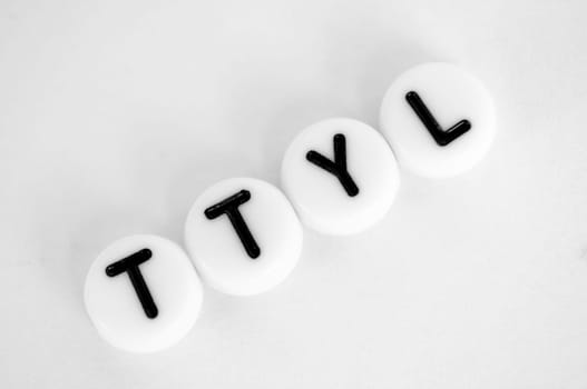 TTYL representing talk to you later text on white background.