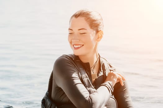 Happy smiling woman in kayak on ocean, paddling with wooden oar. Calm sea water and horizon in background