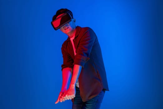 Smart gaming player wearing VR glasses playing golf distance course hologram isolated neon light blue screen connecting digital futuristic technology virtual reality in metaverse world. Contrivance.